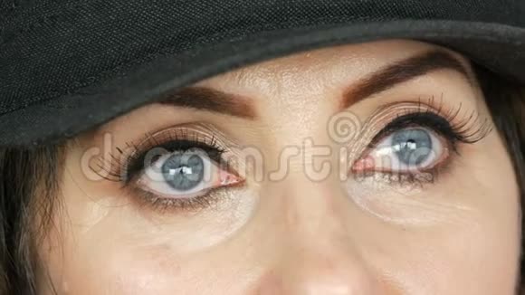 成年美丽的中年妇女漂亮的蓝眼睛明亮的妆容彩绘的箭头和长长的假睫毛视频的预览图