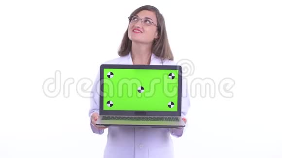 快乐美丽的女医生一边思考一边用笔记本电脑视频的预览图