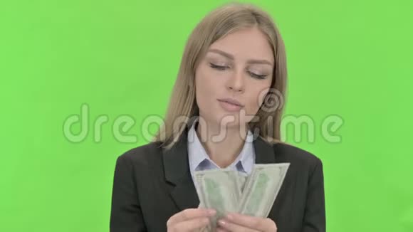 漂亮的女商人把钱数到Chroma键视频的预览图