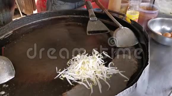 泰国厨师在大煎锅上添加配料视频的预览图