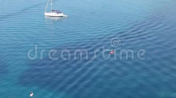 站在蓝色海面上划桨船上的人视频的预览图