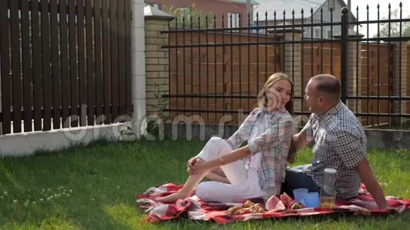 女人和帅哥坐在院子里儿子跳上母亲视频的预览图