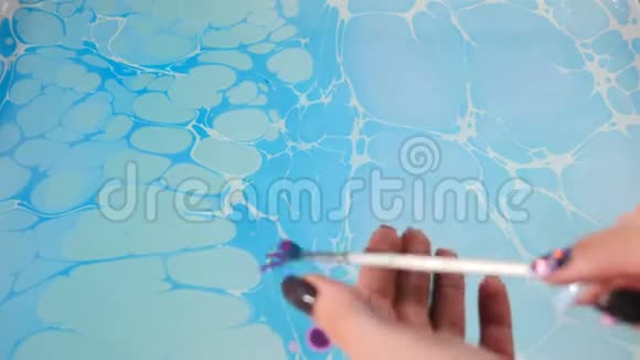 女性埃布鲁艺术家将抽象的油漆墨水在运动迷幻的背景片段五颜六色的斑点埃布鲁艺术关门视频的预览图