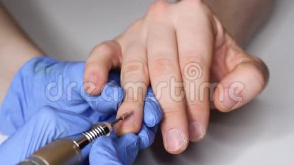 关心男人指甲穿着蓝色手套的美容师给男人修指甲男人美的概念视频的预览图