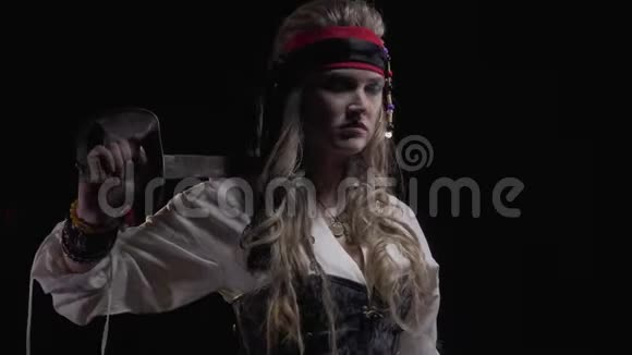 手持宝剑的金发海盗女子站在侧面4k视频的预览图