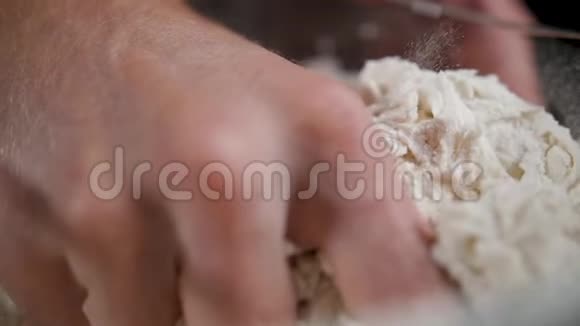 男性在做披萨的时候用手在大锅里搅拌小麦面团视频的预览图