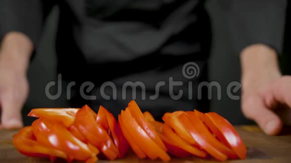 厨师从木桌上取下红色的辣椒视频的预览图