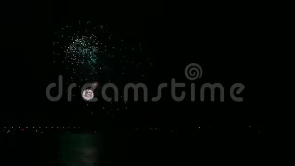 色彩鲜艳的烟花火花在夜空上的河流反射在水中时间跨度视频的预览图