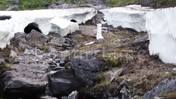 冰裂缝在春天融化下面有一条奔流的小溪视频的预览图
