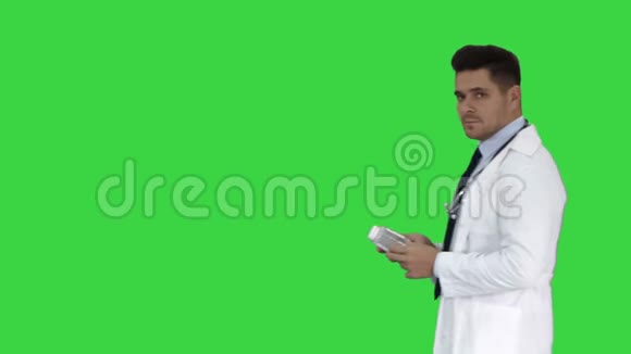 临床医生男医生在绿色屏幕上展示药物药物和与相机交谈铬键视频的预览图