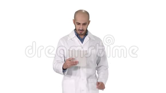 成熟的男性医生拿着数字平板电脑使用它在白色背景上行走视频的预览图