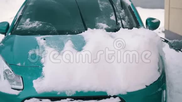 女人把雪从她的车里移走视频的预览图