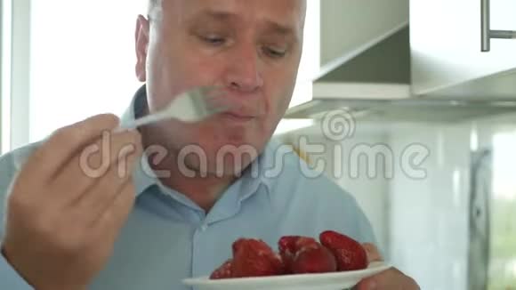 快乐兴奋快乐的人用叉子吃美味的草莓视频的预览图