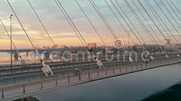 华沙城市景观的空中拍摄日落时有汽车和自行车的桥视频的预览图