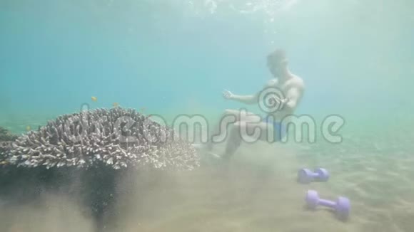 男人戴着面具潜水坐在海底练习呼吸暂停视频的预览图