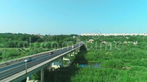降低高度鸟瞰坚固的桥梁和汽车沿它和风景如画的城市地区4K视频的预览图