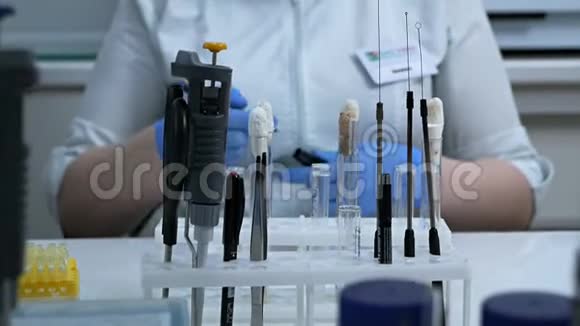 一位女化学家在实验室的桌子上进行化学物质的科学实验研究人员滴水视频的预览图