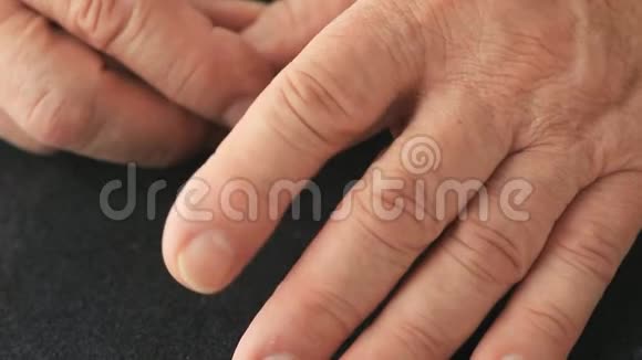 手指震颤的人的特写视频的预览图