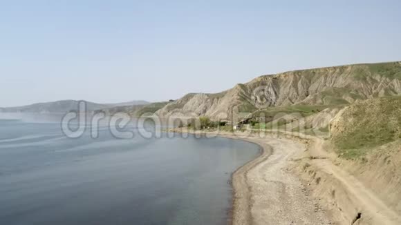 无人机沿着美丽的海岸飞行把山吸引到海岸线视频的预览图