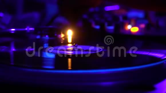 派对上紫色灯光下旋转唱片的特写镜头视频的预览图