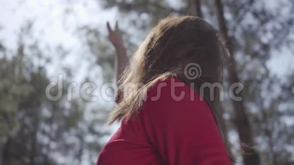 在森林里一幅幅美丽的女子身披红裙女士在天空中举手视频的预览图
