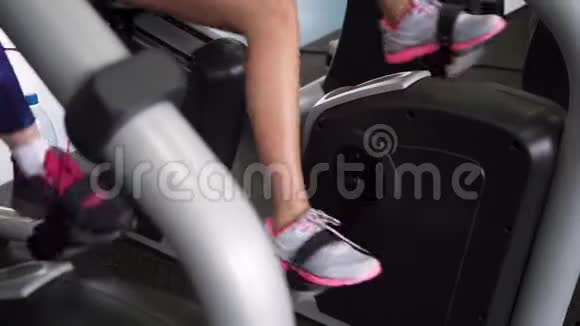 健身女性的腿在健身房的固定周期做有氧运动视频的预览图
