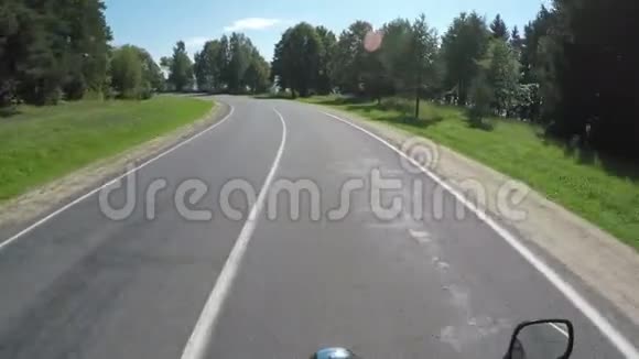 摩托车手在白俄罗斯美丽的风景和空旷的森林道路上骑着车手指着湖面第一批视频的预览图