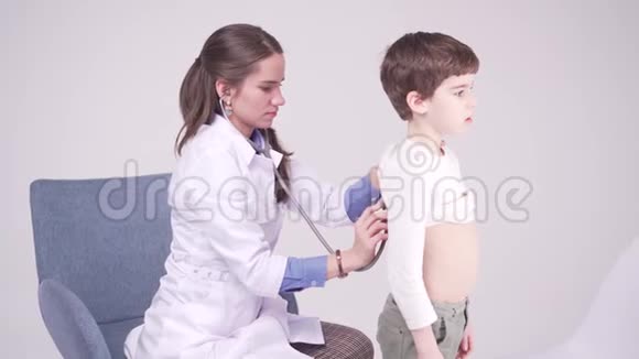 带医生的7岁男孩医生用听诊器检查孩子视频的预览图