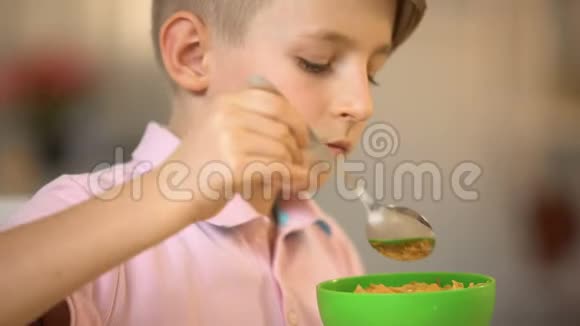 满足的小男孩早餐吃玉米片儿童营养小吃视频的预览图