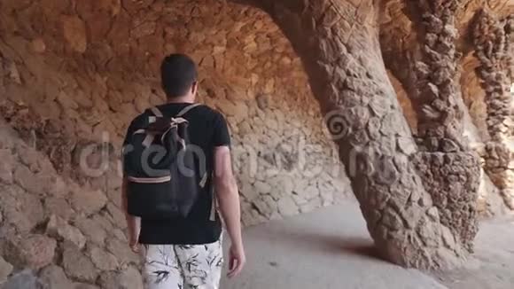 男游客独自走在公园里有柱子的人造石窟小巷里视频的预览图