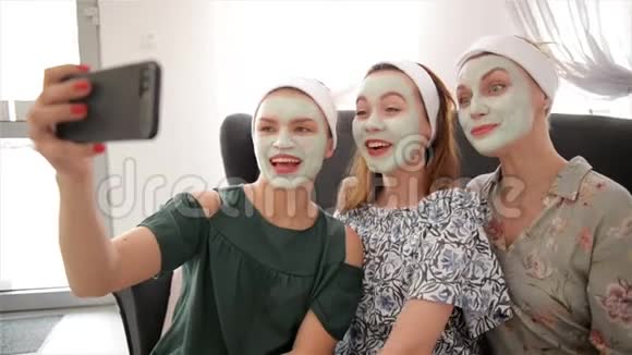 三个年轻快乐的女人带着面具在水疗中心自拍友谊和福利概念健康美视频的预览图