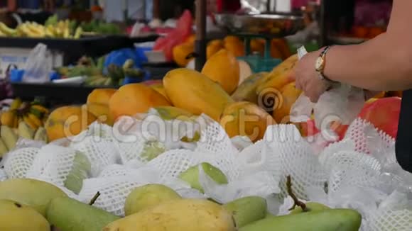 一个女人在亚洲街头市场上选择和购买番石榴4k视频的预览图
