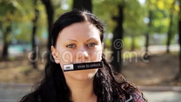 年轻的黑发女人长发和名牌在她的嘴看相机视频的预览图