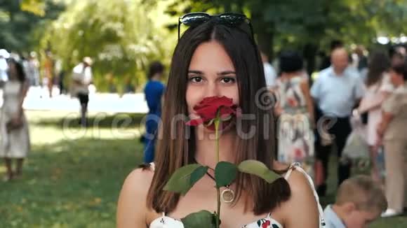 有魅力的年轻女子手中拿着玫瑰的肖像视频的预览图