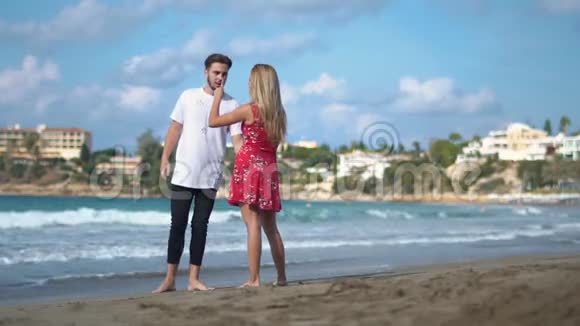 一对年轻夫妇站在岩石海上花了很大的感情男人和女人争吵男人做尖锐的手势视频的预览图