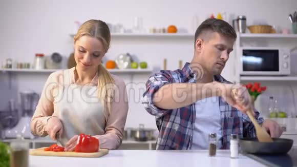 年轻的素食夫妇一起烹饪蔬菜健康的营养快乐的时光视频的预览图