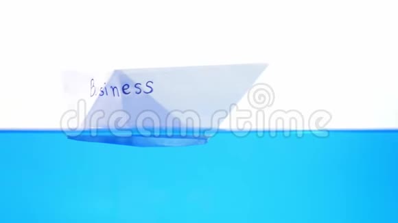 折叠纸船漂浮在水面上商业问题的概念视频的预览图