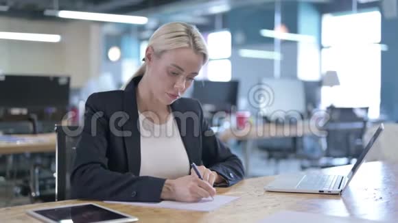 工作期间认真的女商人写论文视频的预览图