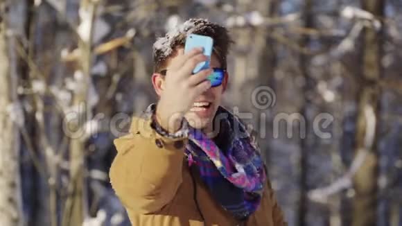 快乐的家伙在镜头前扔雪冬天的心情冬季体育假日圣诞节生活方式的概念拍摄视频的预览图