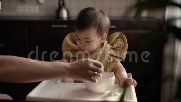 小可爱的女孩吃婴儿粥妈妈用勺子喂宝宝视频的预览图