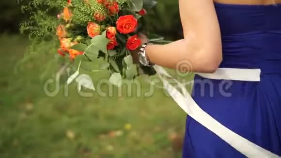 新娘手里拿着一束玫瑰绣球花金丝桃和桉树枝视频的预览图