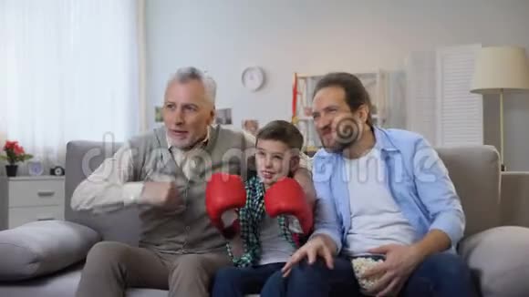 兴奋的家庭成员为喜爱的拳击手在电视上观看比赛欢呼视频的预览图