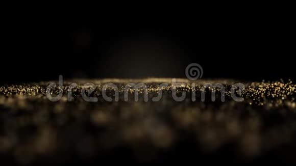 金色闪光模糊的沙子纹理边界上的黑色抽象的视频背景视频的预览图
