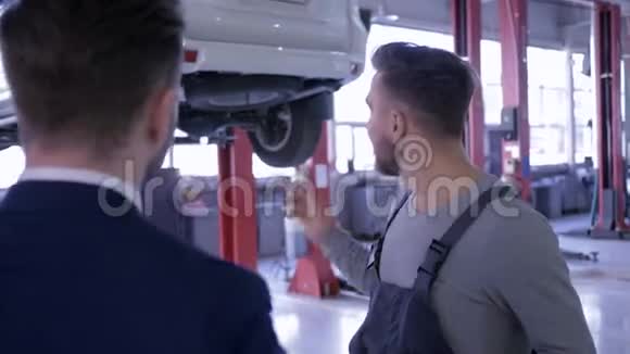 成功的交易机械师和车主男人在电梯上与汽车的背景握手视频的预览图