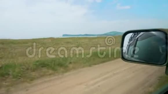 在土路上拍摄移动汽车的镜子视频的预览图