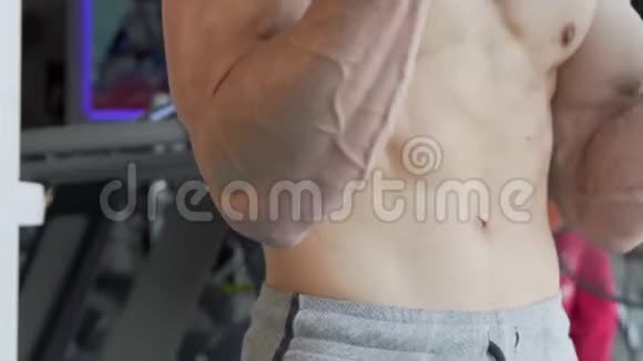 肌肉不可辨认的赤膊男子用杠铃做二头肌卷曲视频的预览图