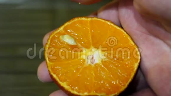人类的手从橘子中射出种子视频的预览图