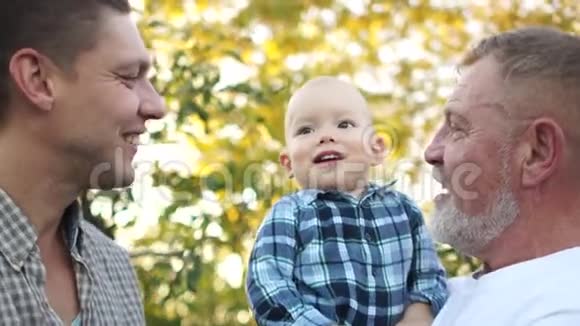 幼儿与爸爸和爷爷一起在夏园亲密的战利品幸福的家庭视频的预览图