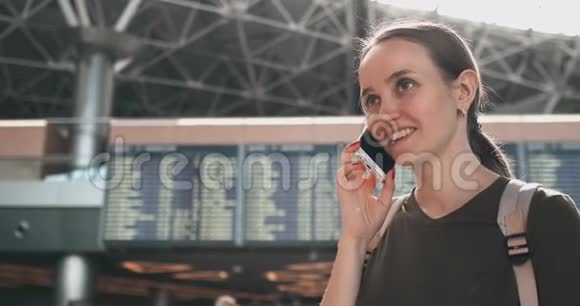 女旅客在机场打电话微笑视频的预览图