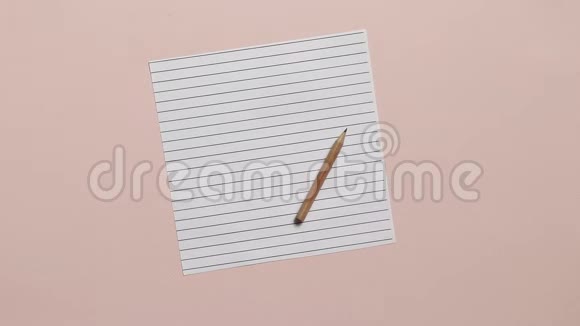 粉红色背景上有铅笔的空纸五颜六色的秋叶飘落在书页上返校概念视频的预览图